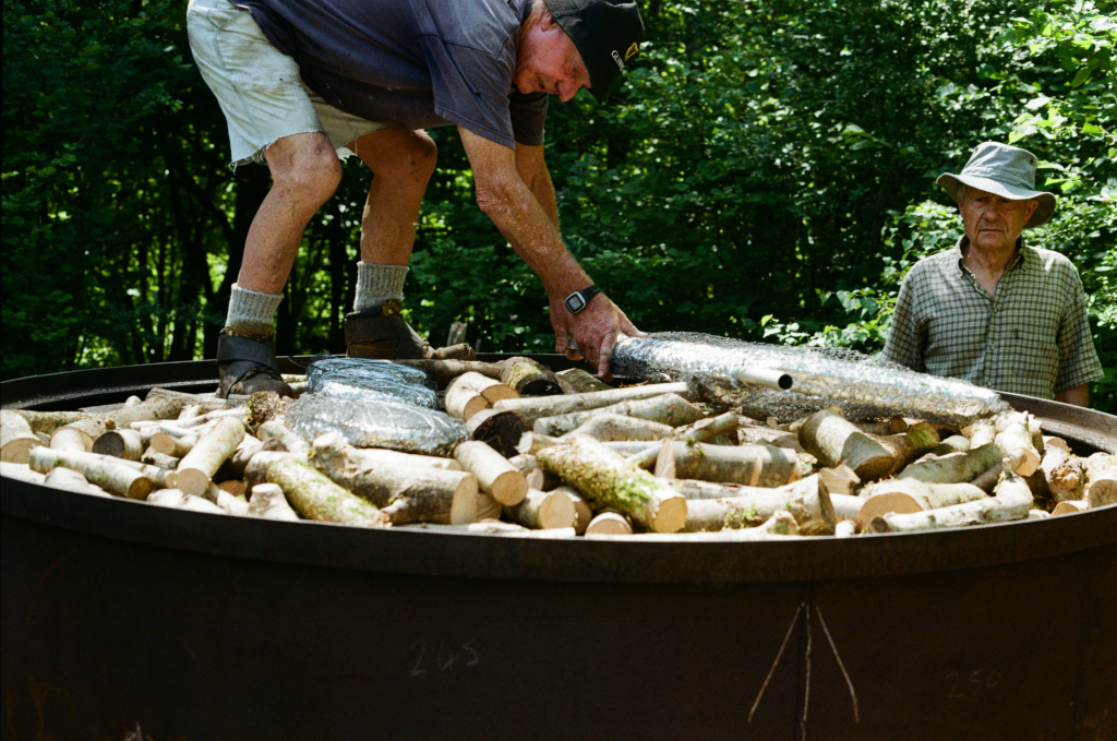 Making charcoal using a charcoal kiln at the Warburg Reserve, Oxfordshire, UK on 26 May 2026. Photo ref: sml-26-May-warburg-kodak-003