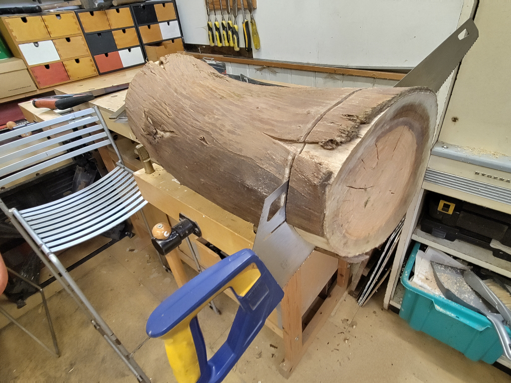 Cutting a section/slice off a red cedar log to create a disc for Residuals #11 in Theo Hopkins workshop. Photo ref: sml-IMG_20260512_155329-Fairphone5